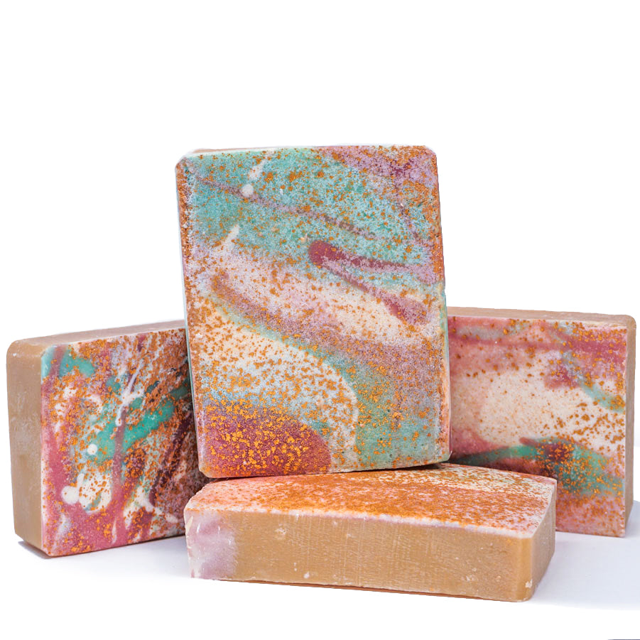 four abstract colorful bar soaps, golden sprinkles, purple and green splatter
